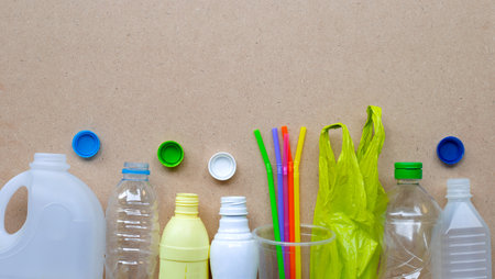 Plastic waste on wooden background. Top view