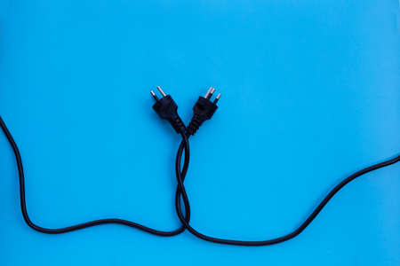 Electric plugs on blue background. Top view