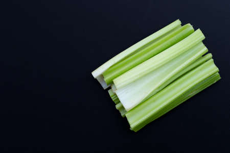 Fresh celery on dark background. Top view