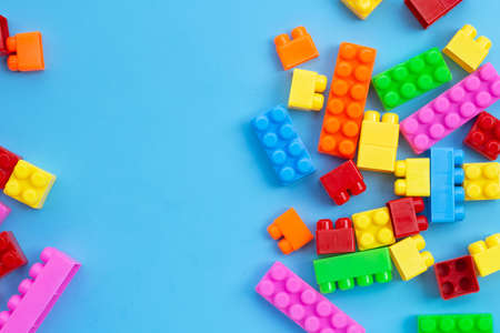 Plastic building blocks on blue background.の写真素材