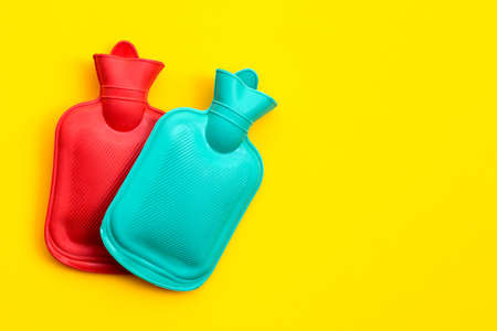 Hot water bags on yellow background. Copy spaceの写真素材