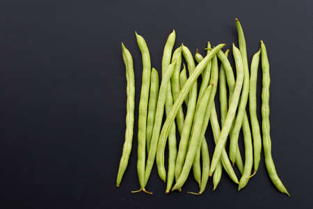 Green beans on dark background. Copy spaceの写真素材
