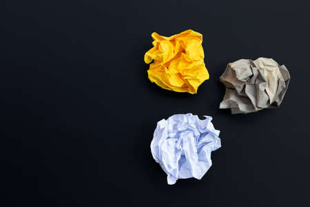 Crumpled paper balls on dark background. Copy spaceの写真素材