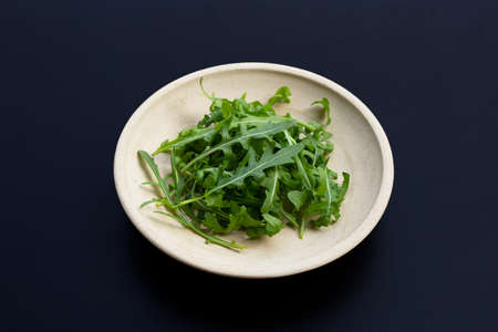 Fresh green rocket salad on dark background.の写真素材