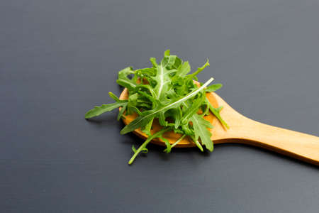 Fresh green rocket salad on dark background.の写真素材