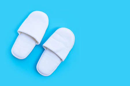 Hotel Slippers on blue background. Copy spaceの写真素材