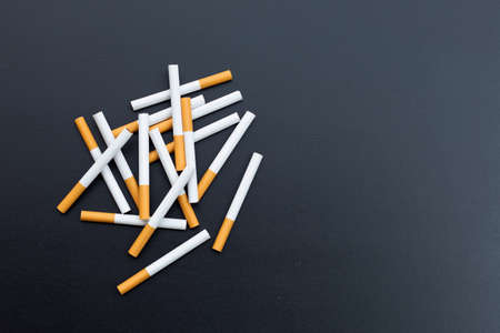 Cigarette on dark background. Non smoking for health conceptの写真素材