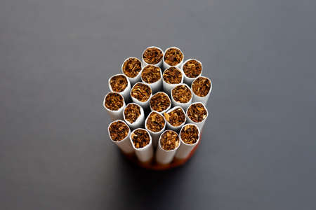 Cigarette on dark background. Non smoking for health conceptの写真素材