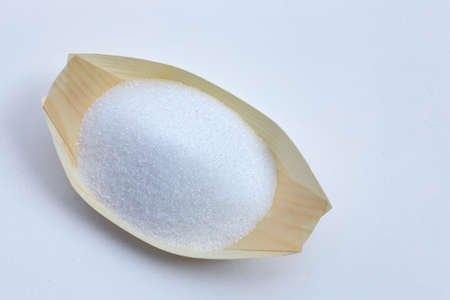 White granulated sugar on white background. Copy spaceの写真素材