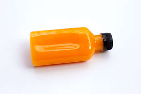 Orange juice in plastic bottle on white background.