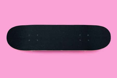 Black skateboard on pink background.の写真素材