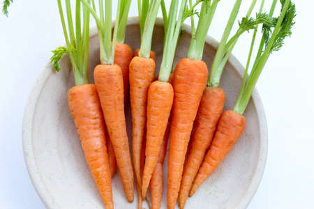 Fresh carrots on white background.