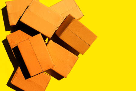 Brown cardboard boxes on yellow background.の写真素材