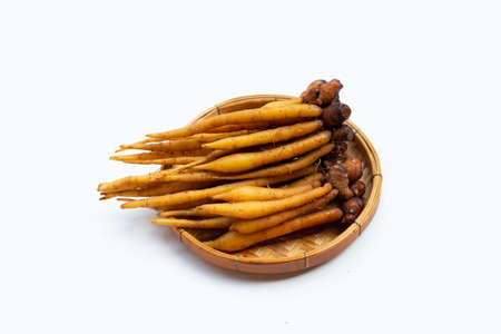 Fingerroot in bamboo basket on white background.