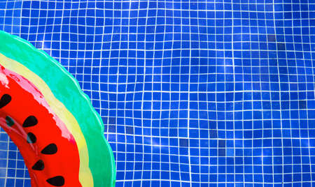 Inflatable ring floating in swimming pool. Summer background concept