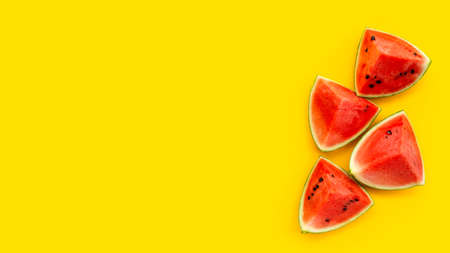 Watermelon slices on yellow background. Top view
