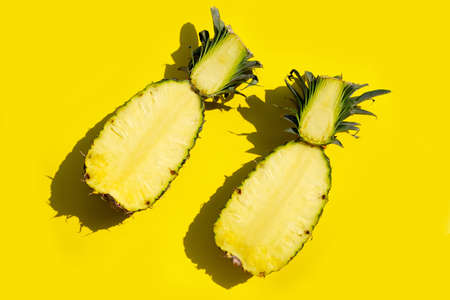 Fresh pineapple on yellow background. Copy space