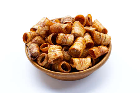 Dried banana rolled chips on white background.の写真素材
