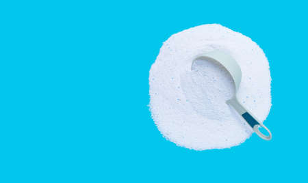 Detergent powder with measuring spoon for clothes washing. Laundry concept.の写真素材
