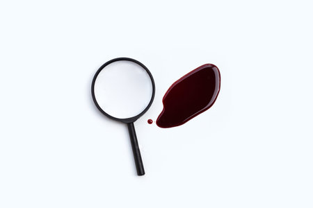 Magnifying glass with blood on white background.の写真素材