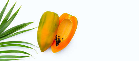 Papaya fruit with tropical palm leaves on with background. Top view