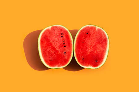 Fresh watermelon on orange surfaceの写真素材