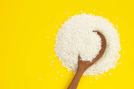 Raw sticky rice on yellow background.の写真素材