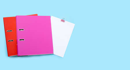 Office folders with paper on blue background. Top viewの写真素材