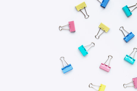 Colorful office paper clips on white background.の写真素材