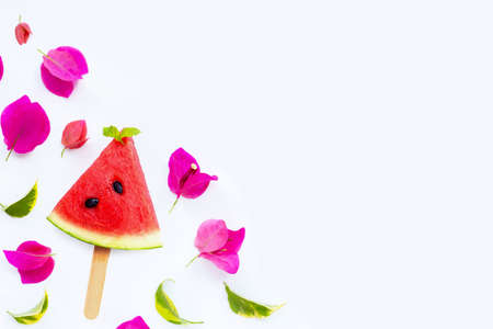 Watermelon slice popsicle with bougainvillea flower on whiteの写真素材