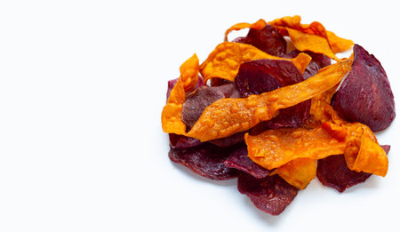 Purple and yellow sweet potato chips on white background.の写真素材