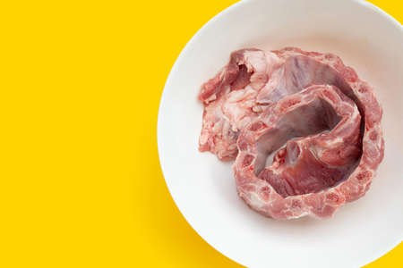 Raw pork ribs in white bowl on yellow background.の写真素材