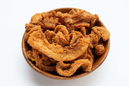 Fried crispy pork belly recipe in wooden bowl on white background.の写真素材