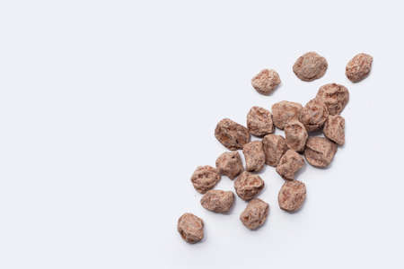 Dried salted Chinese plum isolated on white backgroundの写真素材