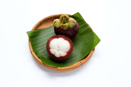 Mangosteen in bamboo basket on white background.の写真素材