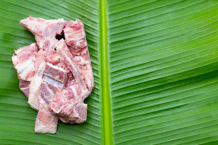 Raw pork bone on banana leafの写真素材