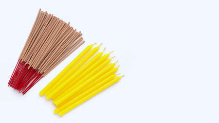 Stack of incense sticks with candles on white background.の写真素材