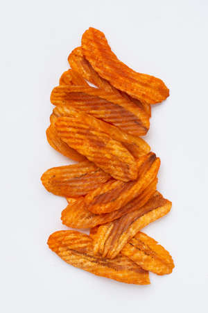 Spicy snack, Banana slice chips paprika flavor on white background.の写真素材
