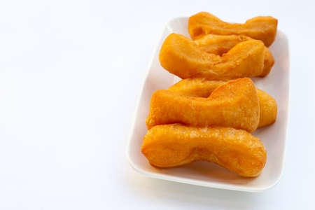 Deep-fried dough sticks or chinese bread sticks on white background.の写真素材