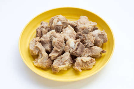 Boiled pork ribs in yellow plate on white background.の写真素材