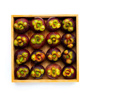 Mangosteen in wooden box on white background.の写真素材