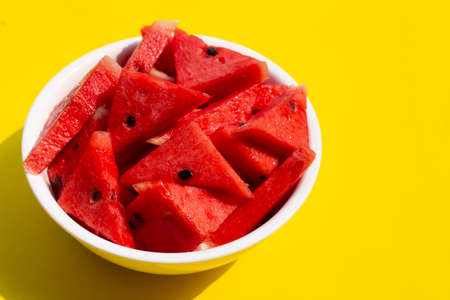 Watermelon in white bowl on yellow background.の写真素材
