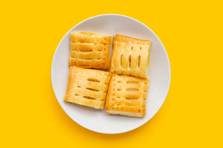 Pineapple pie in white plate on yellow background.の写真素材