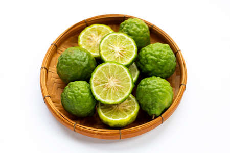 Bergamot kaffir lime in bamboo basket on whiteの写真素材