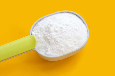 Baking soda on yellow background.の写真素材