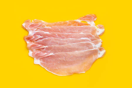 Sliced raw pork meat on yellow background.の写真素材