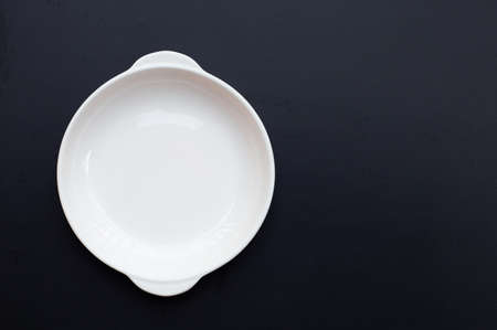 White dish on dark background.の写真素材
