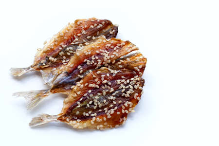 Dried fish with sesame seeds on white background.の写真素材
