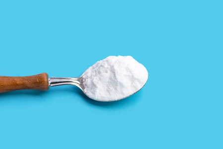 Baking soda on blue background.の写真素材