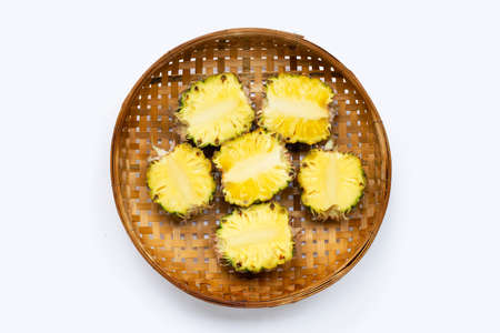 Pineapple in bamboo basket on white background.の写真素材
